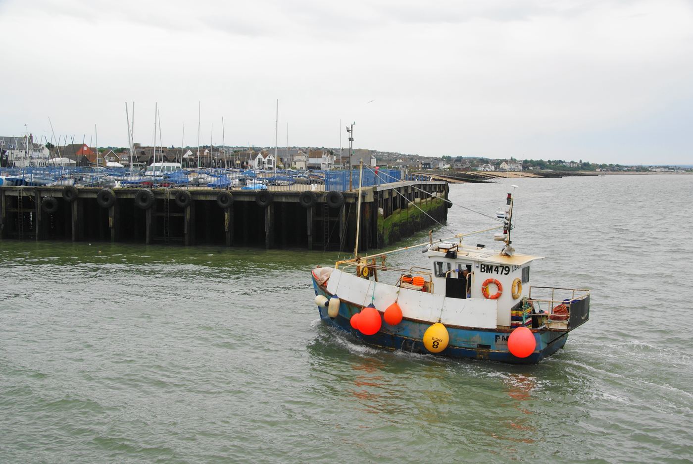 A fishing boat returning to Whitstable harbour
